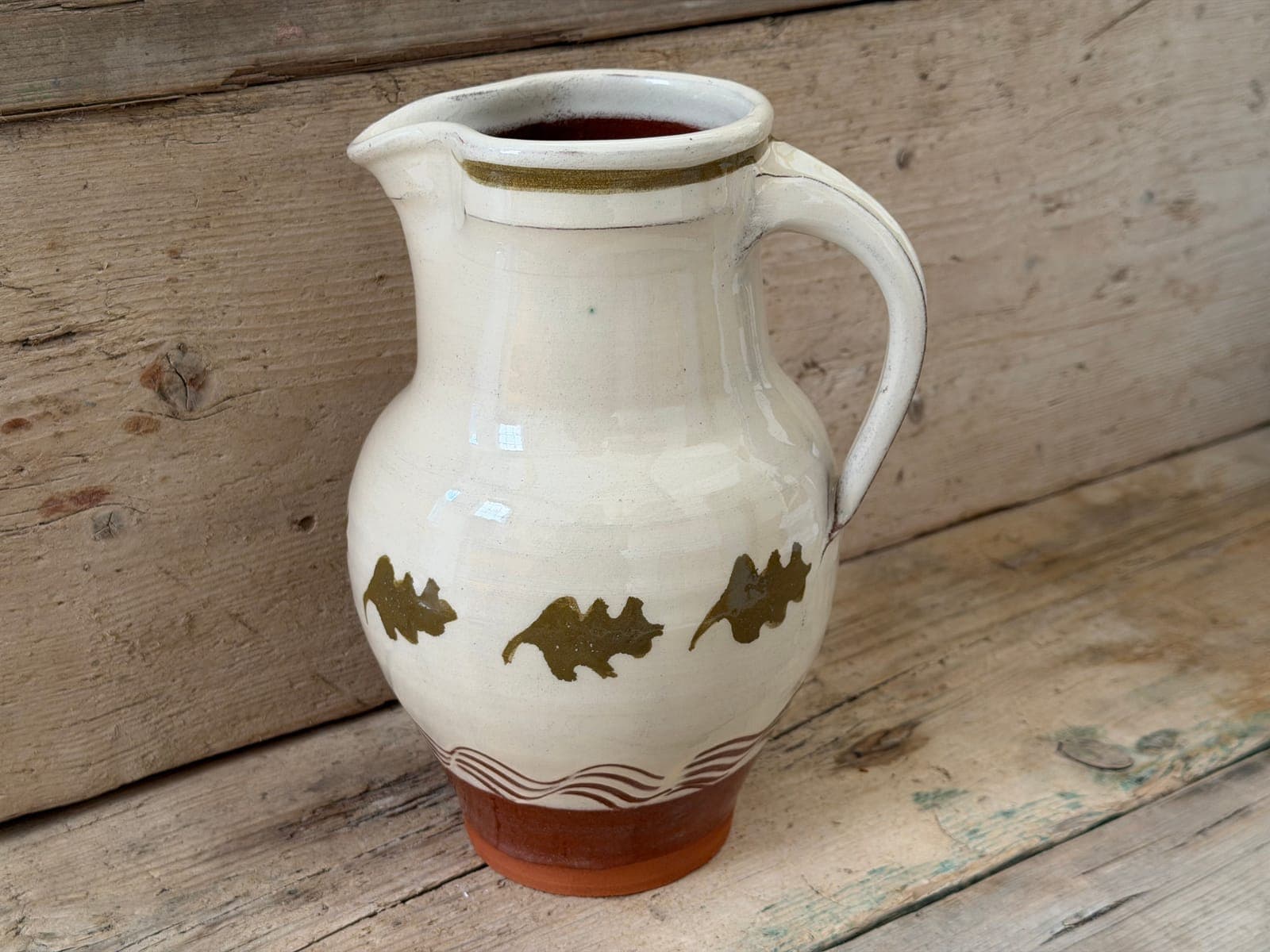 Oak Leaf slipware large jug in cream slip with a band of olive oak leaves and red terracotta foot